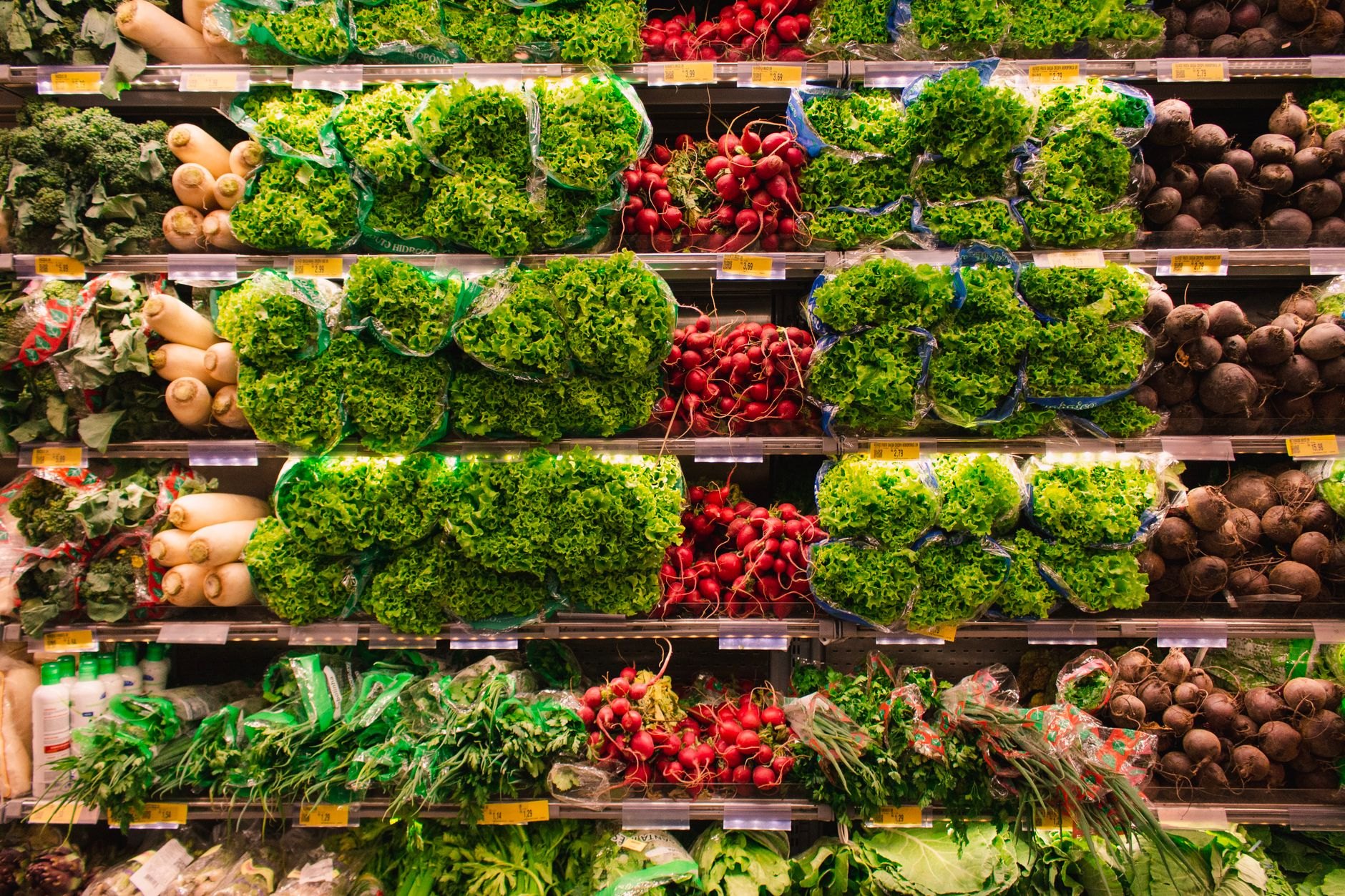 Colourful fresh vegetables arranged in supermarket produce aisle