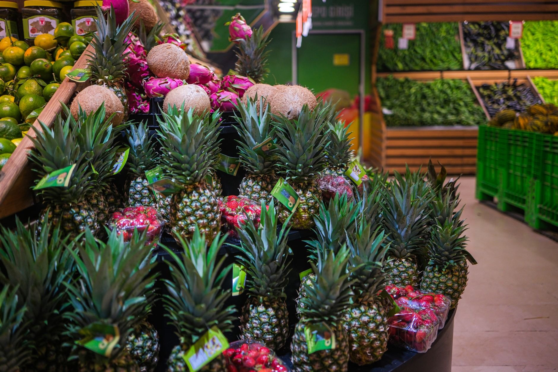 Exotic tropical fruits piled high in colourful supermarket display