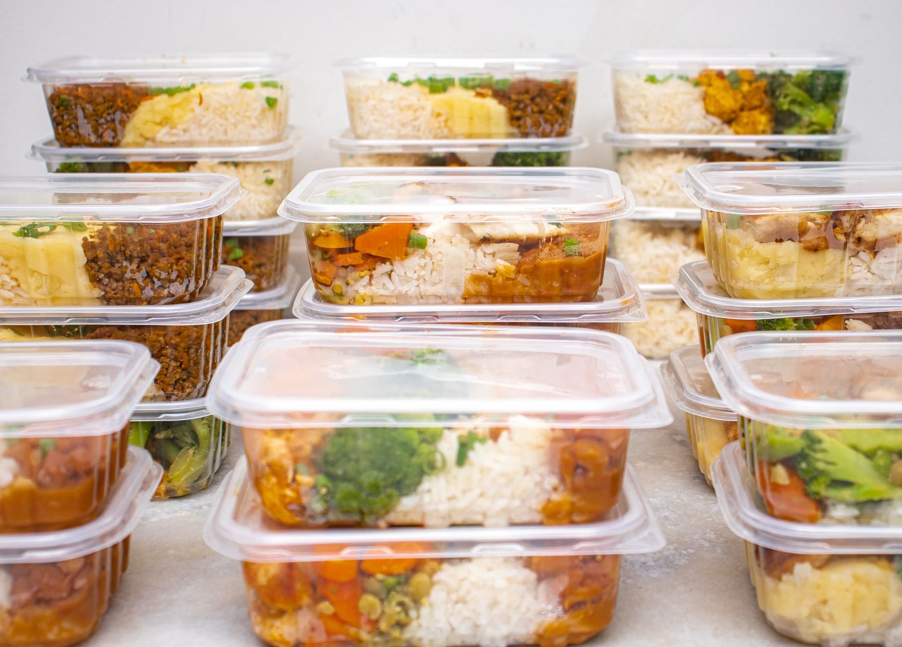 Assorted frozen ready meals and vegetables in freezer aisle