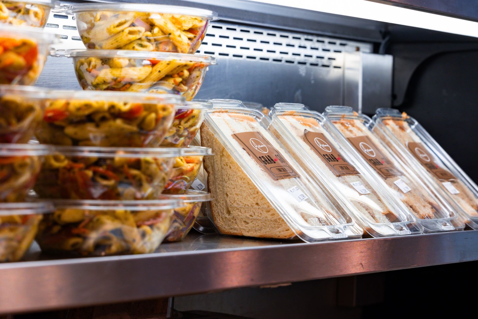 Freshly prepared food platters and deli items in refrigerated display