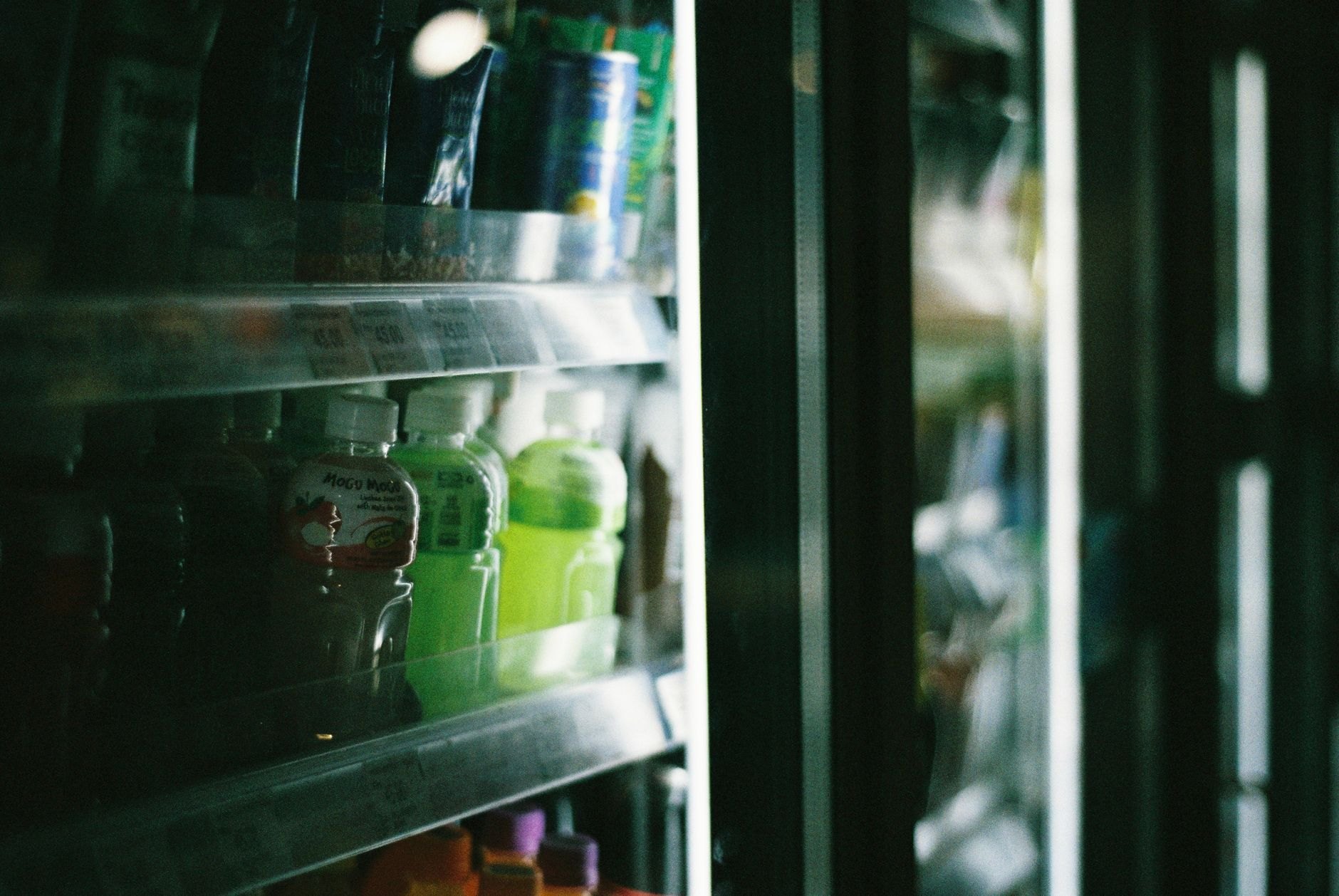 Chilled juices, soft drinks and water bottles in refrigerated aisle