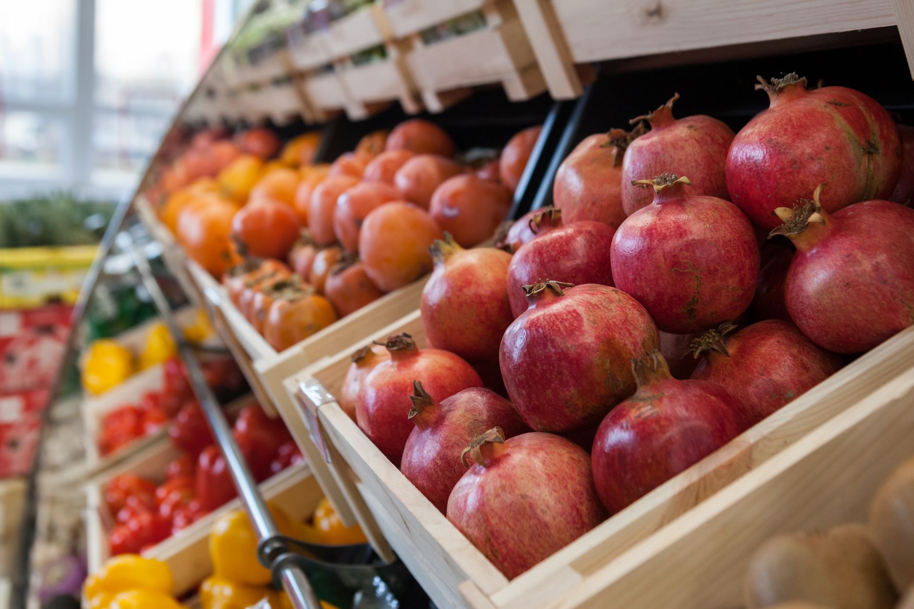 Bright supermarket aisle stocked with fresh fruits and vegetables