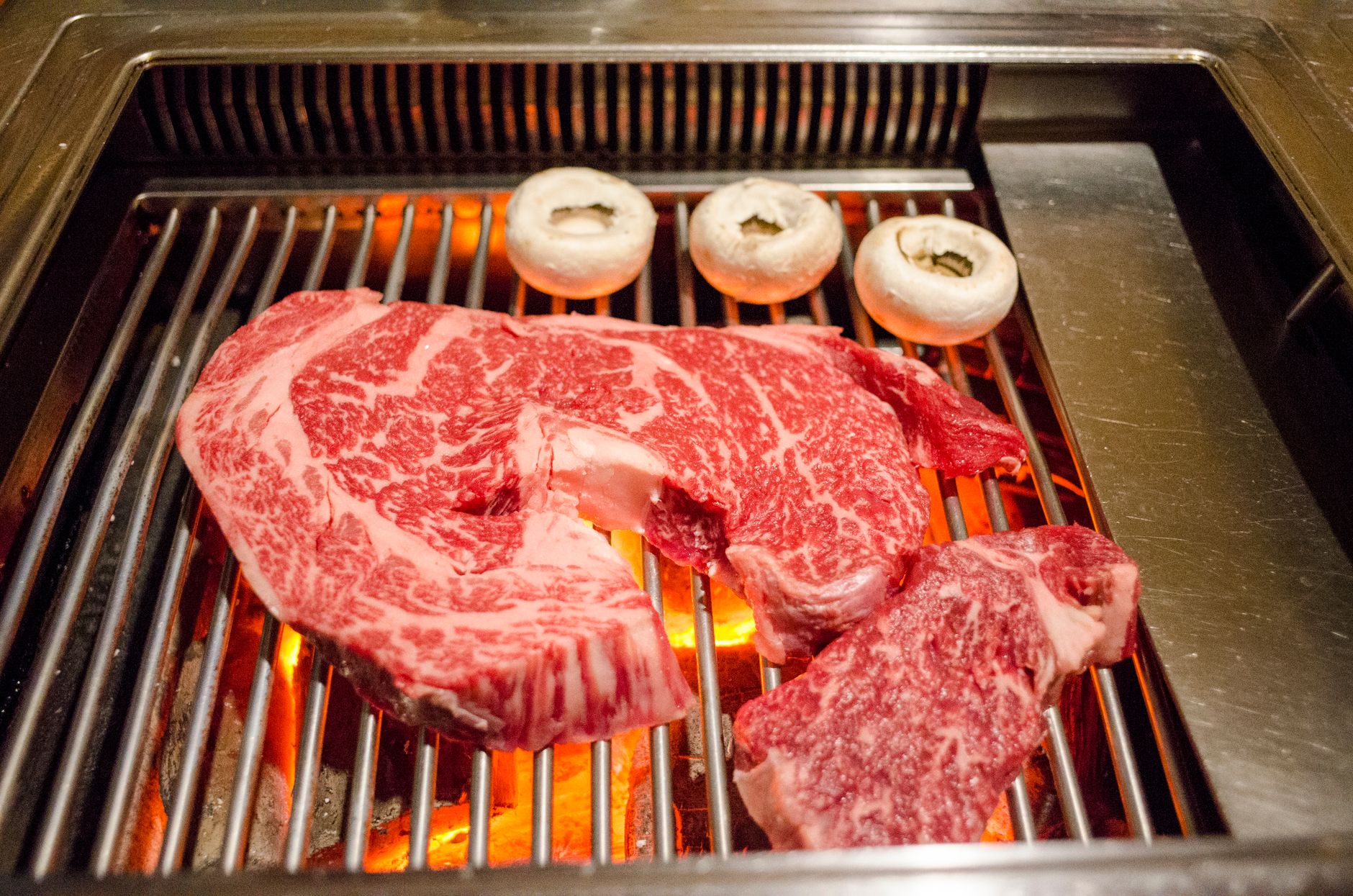 Selection of prime beef joints and mixed barbecue cuts ready for purchase